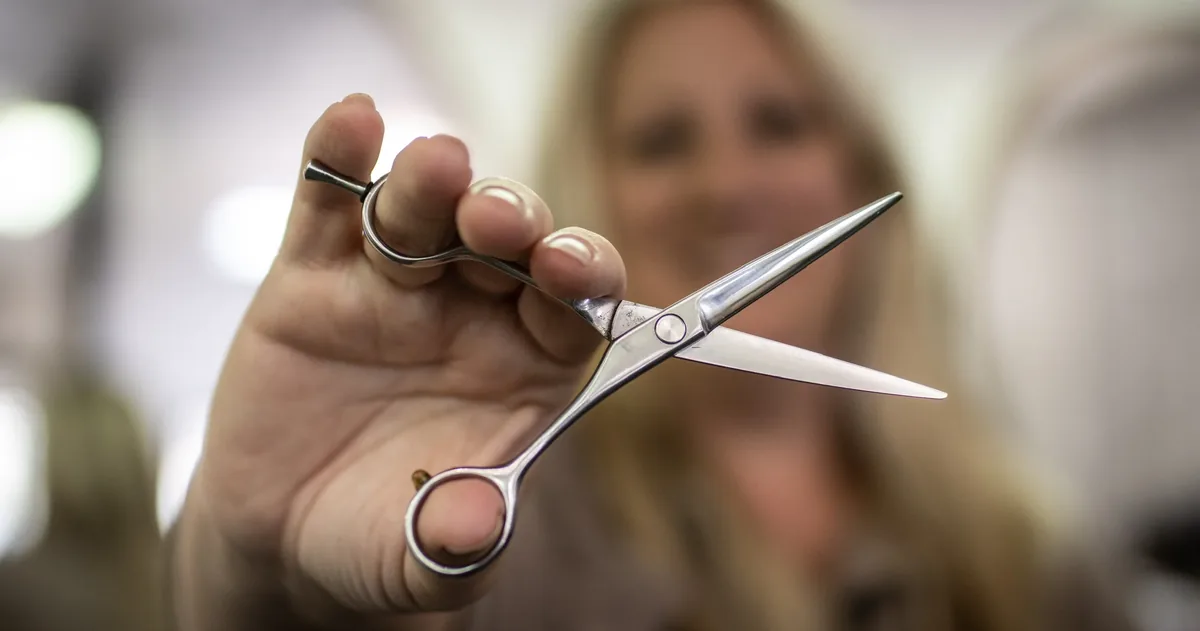 A Brushed On Main stylist holding professional shears