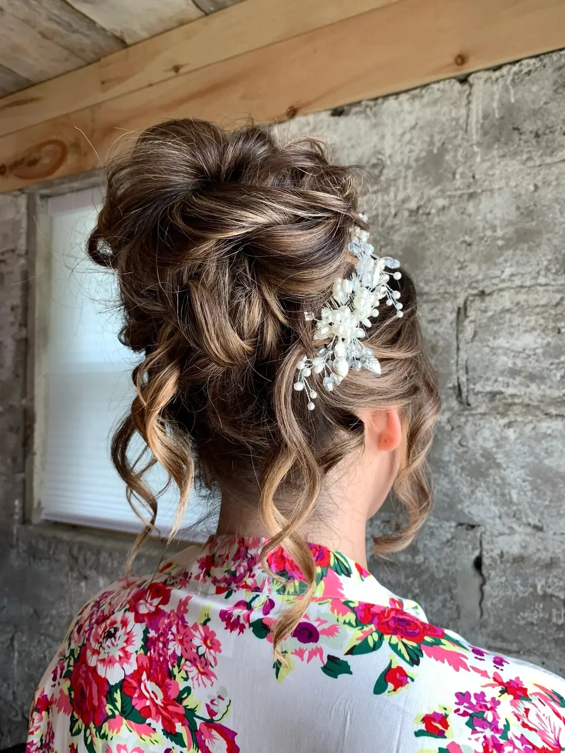 Textured updo with pearl floral hairpiece