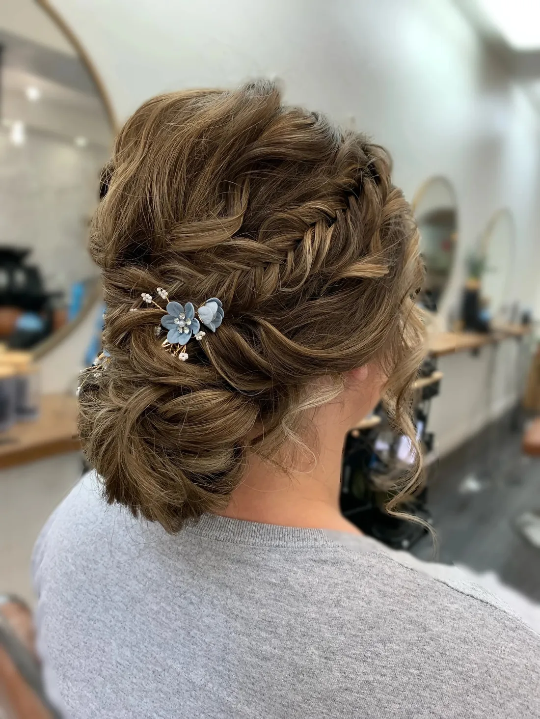 Braided updo with blue floral pin